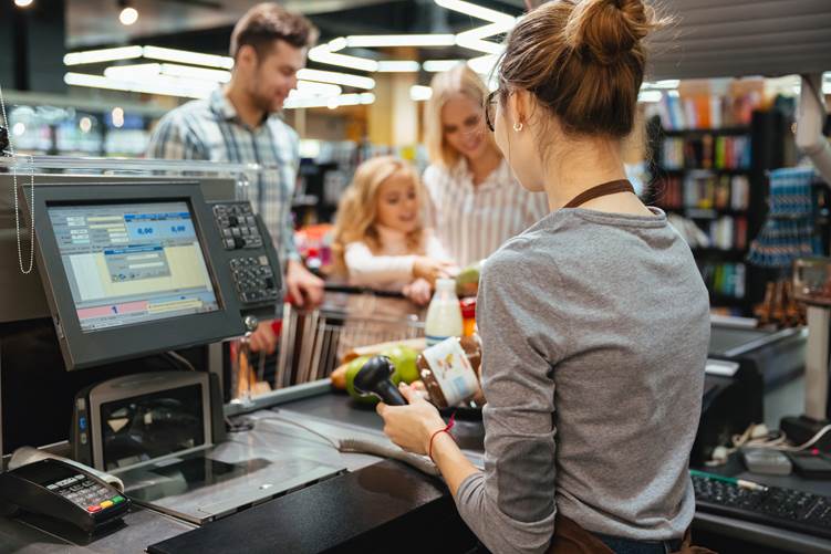 Retail checkout area showing the customer, cashier, and transaction workspace.