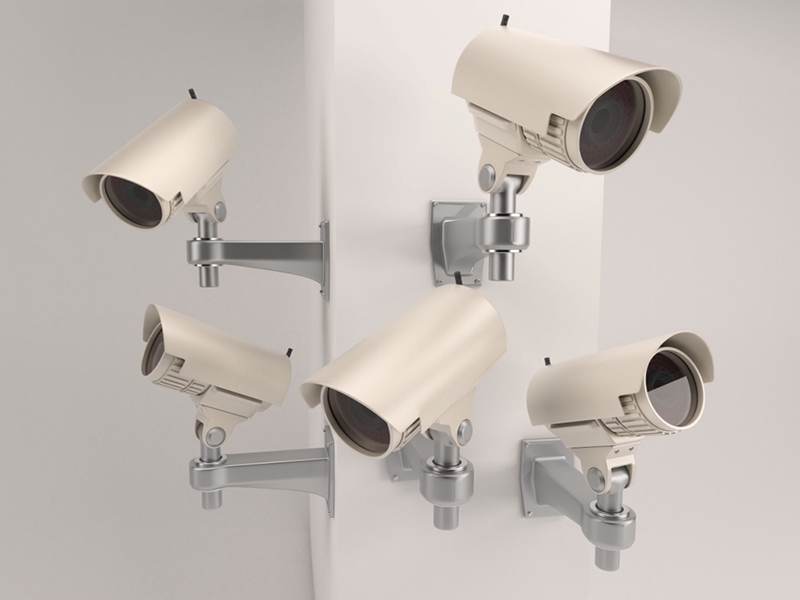 Several security camera housings illustrating that appearance alone does not identify the transmission format.
